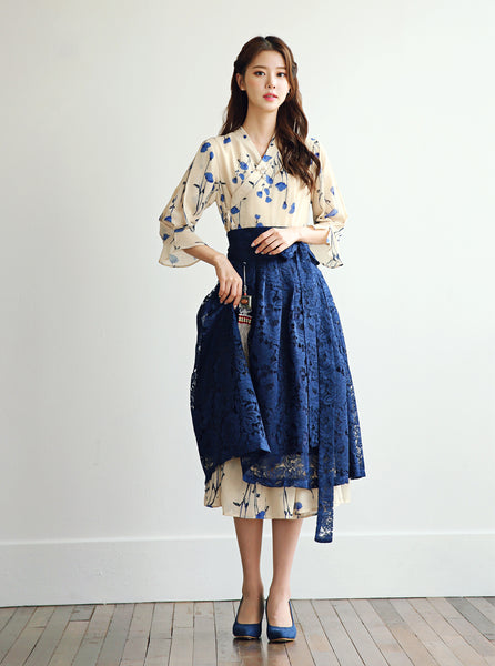 A modern hanbok dress in indigo and fawn still retains the traditional elements of the Korean hanbok, but is designed to be worn anytime for any special occasion.