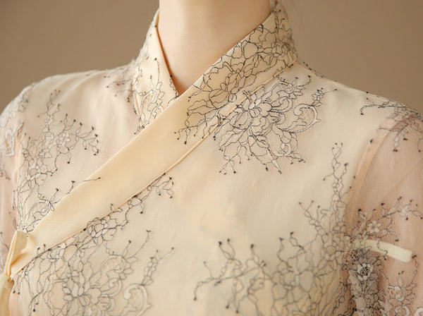 In this up-close shot you can see the flower detail in this off-white modern hanbok dress, which will bring you compliments anywhere you go.
