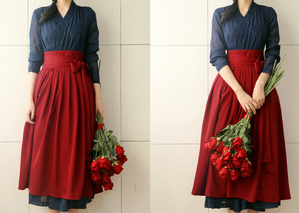 The sea blue modern hanbok dress can be worn with traditional Korean clothing or with a pair of jeans.