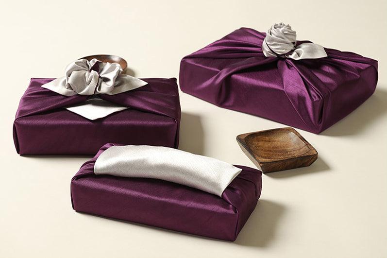 A side view of the pewter and periwinkle Bojagi gift wrap shows you how you can add flair to it with handles for an intricate finishing touch.