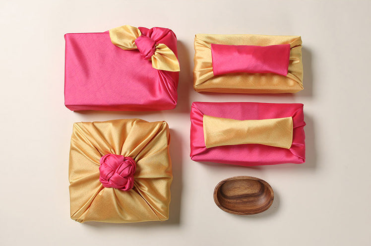 The coral and gold fabric gift wrapping adds an ornate look to any function and makes the present pop.