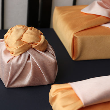 An up close look at the carrot and sandy Korean Bojagi luxury gift wrap offered on our website.