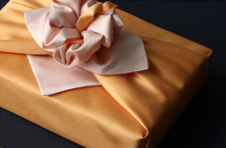 This reusable gift wrap in golden and bittersweet makes for an awesome choice to wrap presents with fabric.