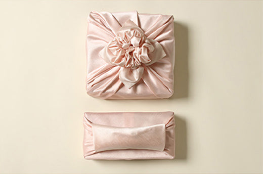 Light coral and flush are great choices for fabric wrapping cloth if you're attending a baby girl Doljanchi.