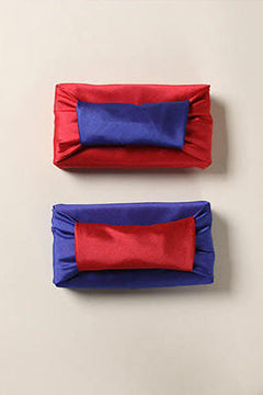 Spiffy decorative knots or handles bring a touch of uniqueness to the Merlot red and sea blue Bojagi Korean wrapping paper.