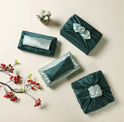 Wrapping presents with fabric, such as this Oxford blue and sap, is bringing a personal touch to any gathering.