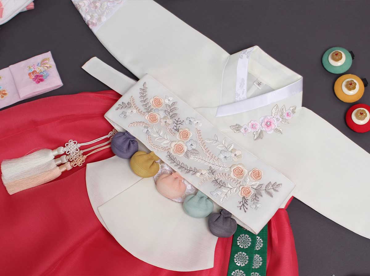 A Dol belt comes with the Dol version of the baby girl cherry red and light ivory hanbok.