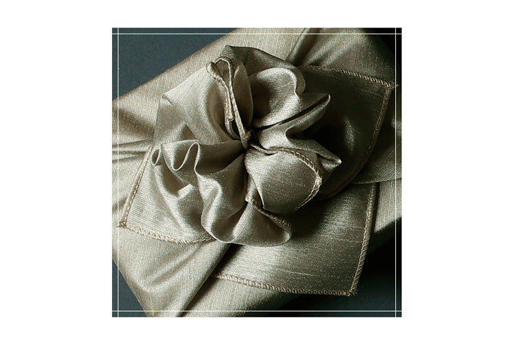 Learn how to impress your friends with the bow on the gray single sided Bojagi gift wrapping paper.