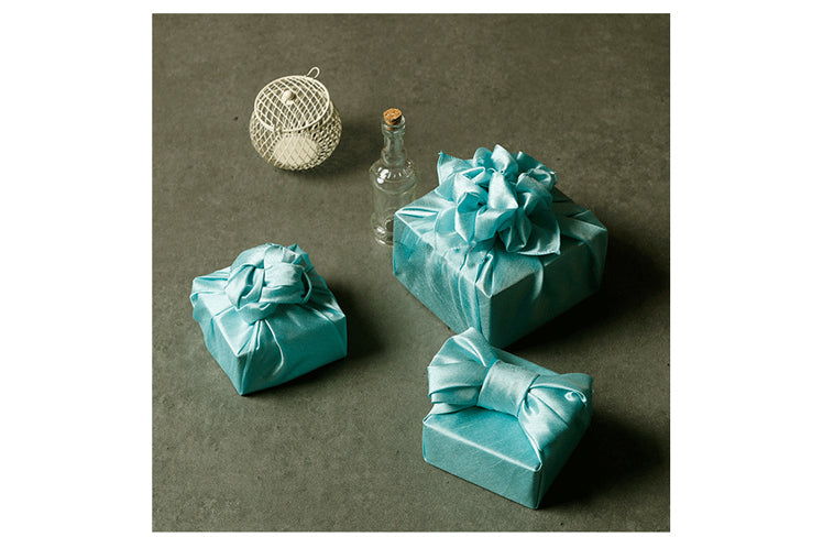 Wrapping presents with fabric is personal and playful and a great way to add personality to the gift.