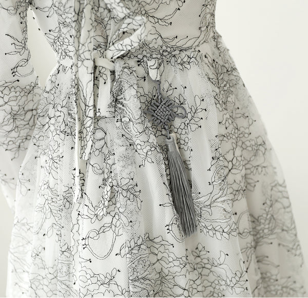 An up-close look at the jet black floral print on the ivory floral modern hanbok dress.