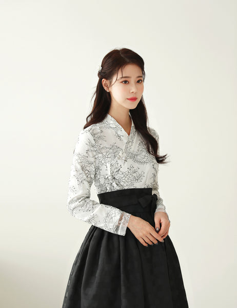 A charming and delightful way to add traditional Korean culture to your daily life is by wearing this rich white and charcoal floral modern hanbok dress.