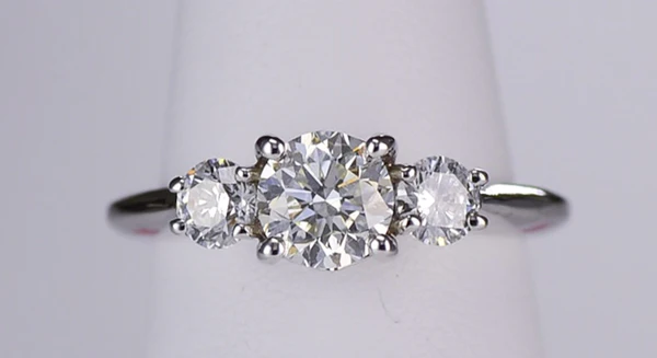 Three stone engagement ring with a one carat center stone