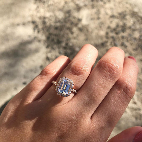 Emerald cut engagement ring with a diamond halo