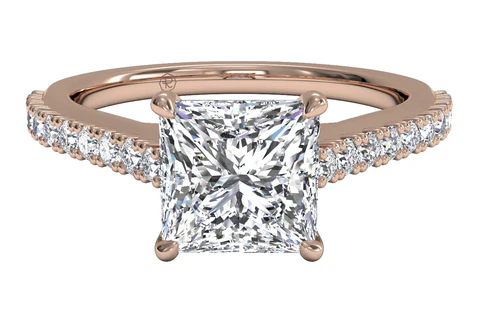 sidestone rose gold engagement ring with a princess cut diamond center stone