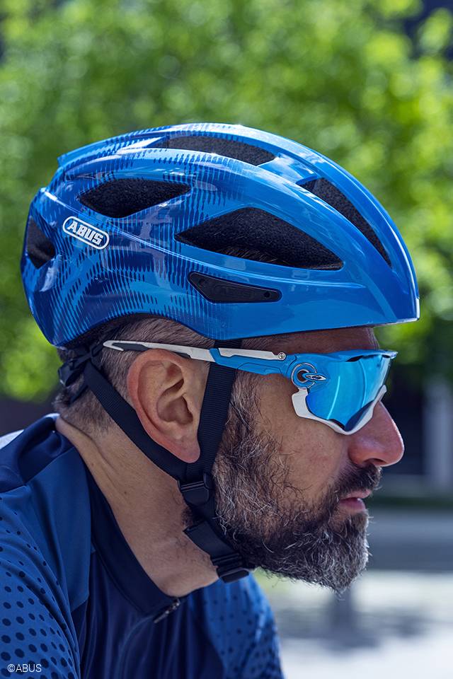 cyclist wearing abus macator bicycle helmet in steel blue, sidev iew