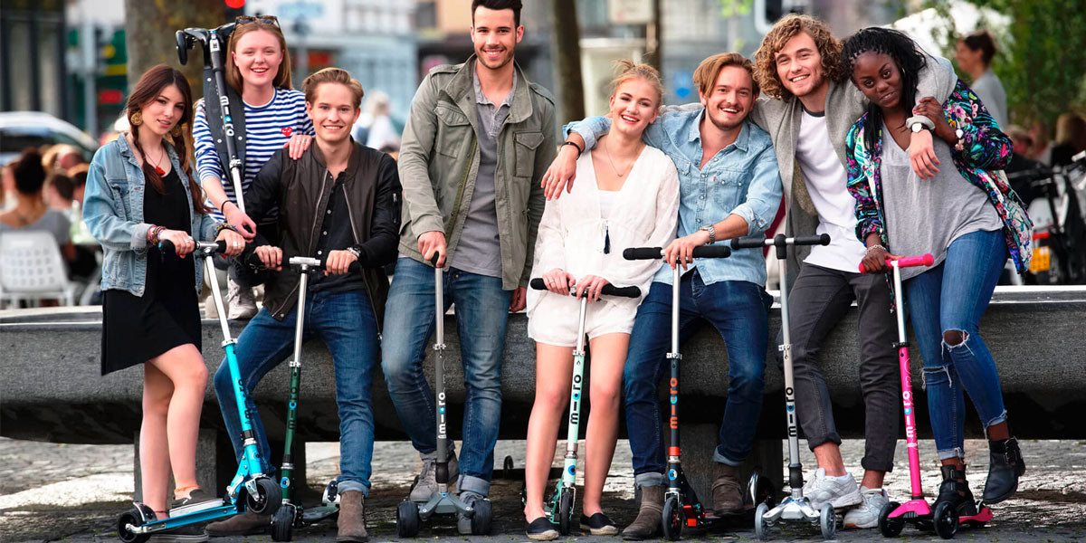 group of teens and adults with micro kick scooters