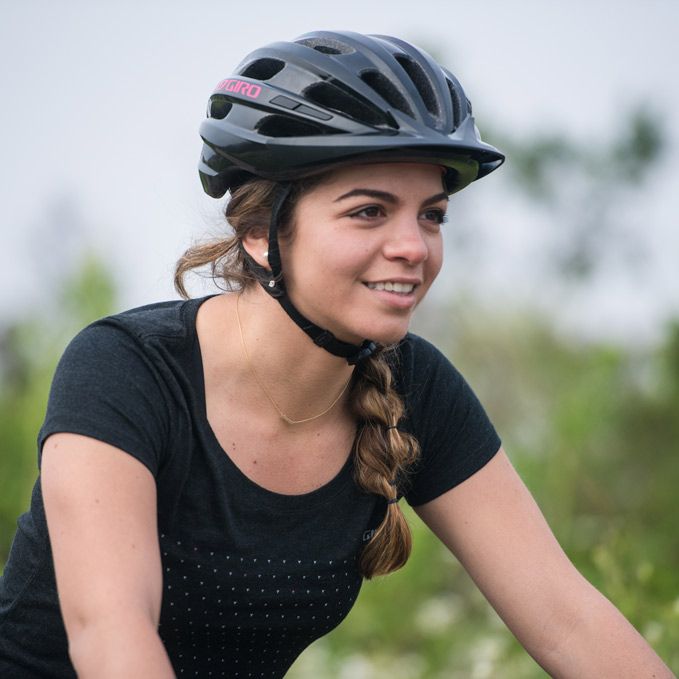 Woman wearing the Giro Register recreation bicycle helmet