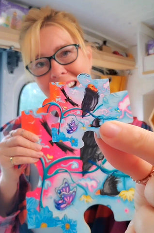 Megan Aroon Duncanson Holding her Original California Condor Original Puzzle Piece Painting and the tiny Magnet of the Same image