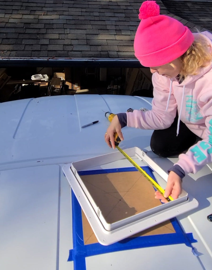 cutting out the hole for my maxx air fan on top of my ford transit van, self conversion by solo female blogger artist meganaroon copy