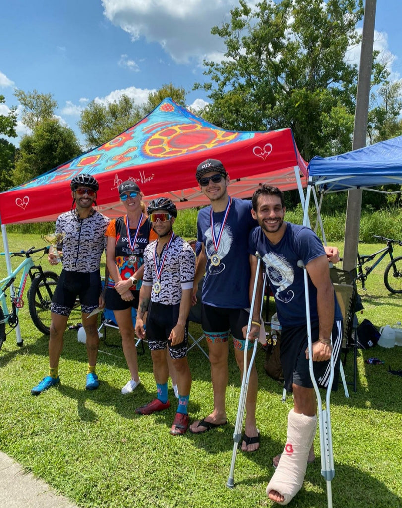 mad shredders mountain bike racing team sporting all of their medals and trophies at a gone riding race at carter lake in lakeland florida
