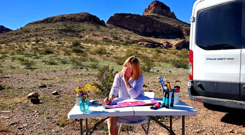 meganaroon the traveling artist and blogger, painting outside at saddle mountain arizona, the outdoors is her art studio solo female van lifer over 50