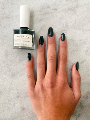 Dark green manicure featuring NailKind's Susan Rover