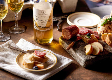 A charcuterie board paired with Tanglewood Winery's Traminette White Wine.