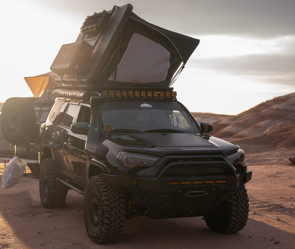 Hard Top tent mounted to a toyota 4runner set up in the desert during a camping trip
