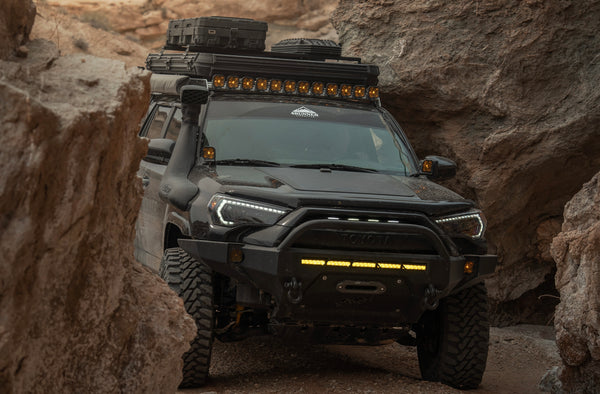 hard top tent mounted on a toyota 4runner driving in a slot canyon in southern utah