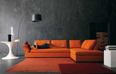 The dramatic use of charcoal walls with vibrant orange rug and furnishings makes a huge visual impact - Image: mydecorative.com