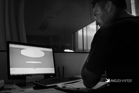 Surfboard Shaper on his computer designing a surfboard using the AKU Shaper software.