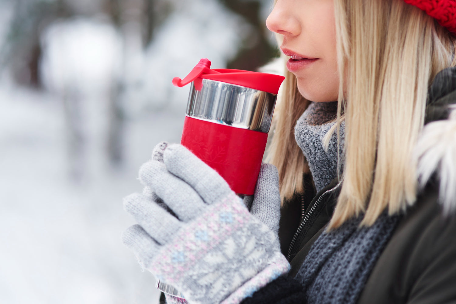 Female Sipping Hot Tea From an Insulated Water Bottle
