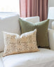  Lisa Fine Textiles muted floral print pillow sitting on white sofa with complimentary green mohair pillow