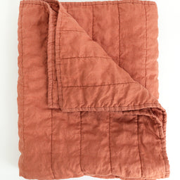 Folded warm rust colour handmade Linen Quilt