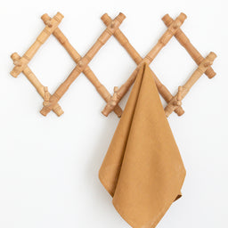 Hanging linen tea towel in brown earth-tone