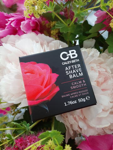 Caley-Beth After Shave Balm laying in beautiful pink and green flowers.