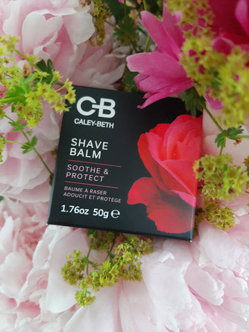 Caley-Beth Shave Balm laying in beautiful pink and green flowers