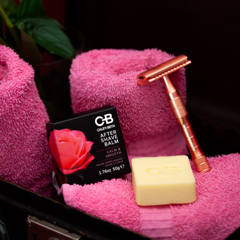 Caley-Beth After Shave Balm with safety razor on pink towel. 