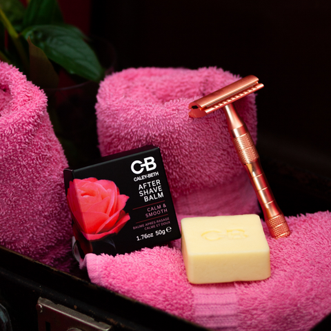 Caley-Beth, Toronto, Ontario.  Zero-waste soothing botanical After Shave Balm bar on a pink towel with a rose gold safety razor.