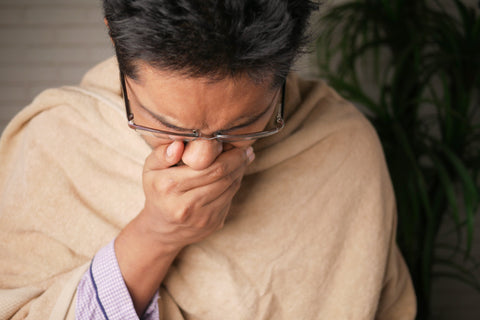 elderly women experiencing incontinence while coughing