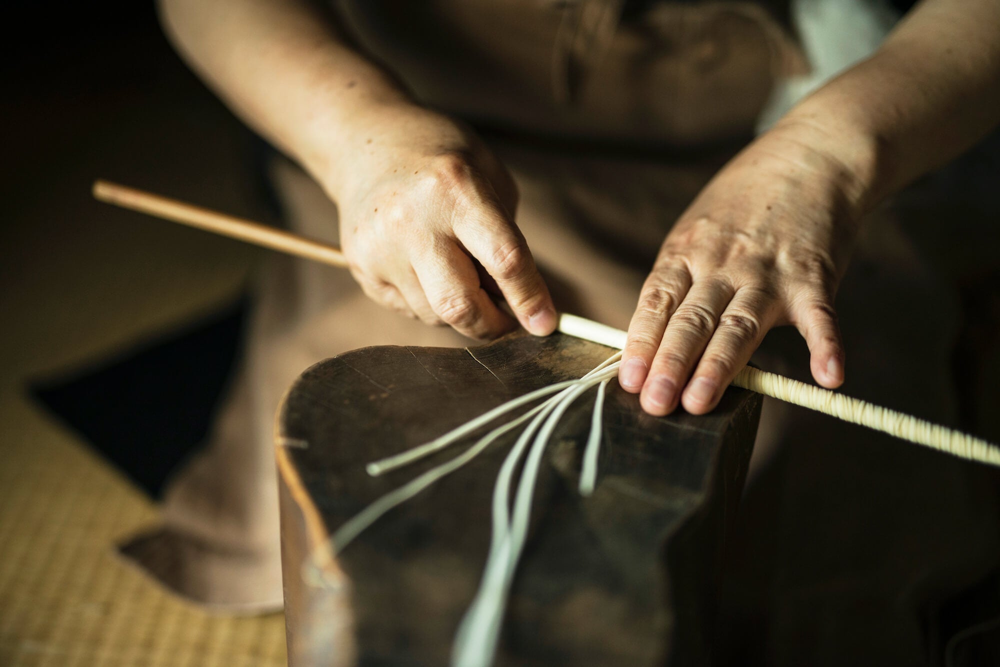 Takazawa artisan in Japan making a candle wick