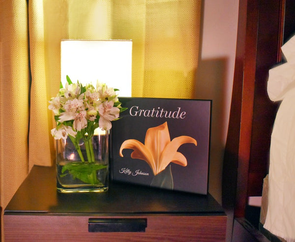 Kelly Johnson's book Gratitude on a nightstand.