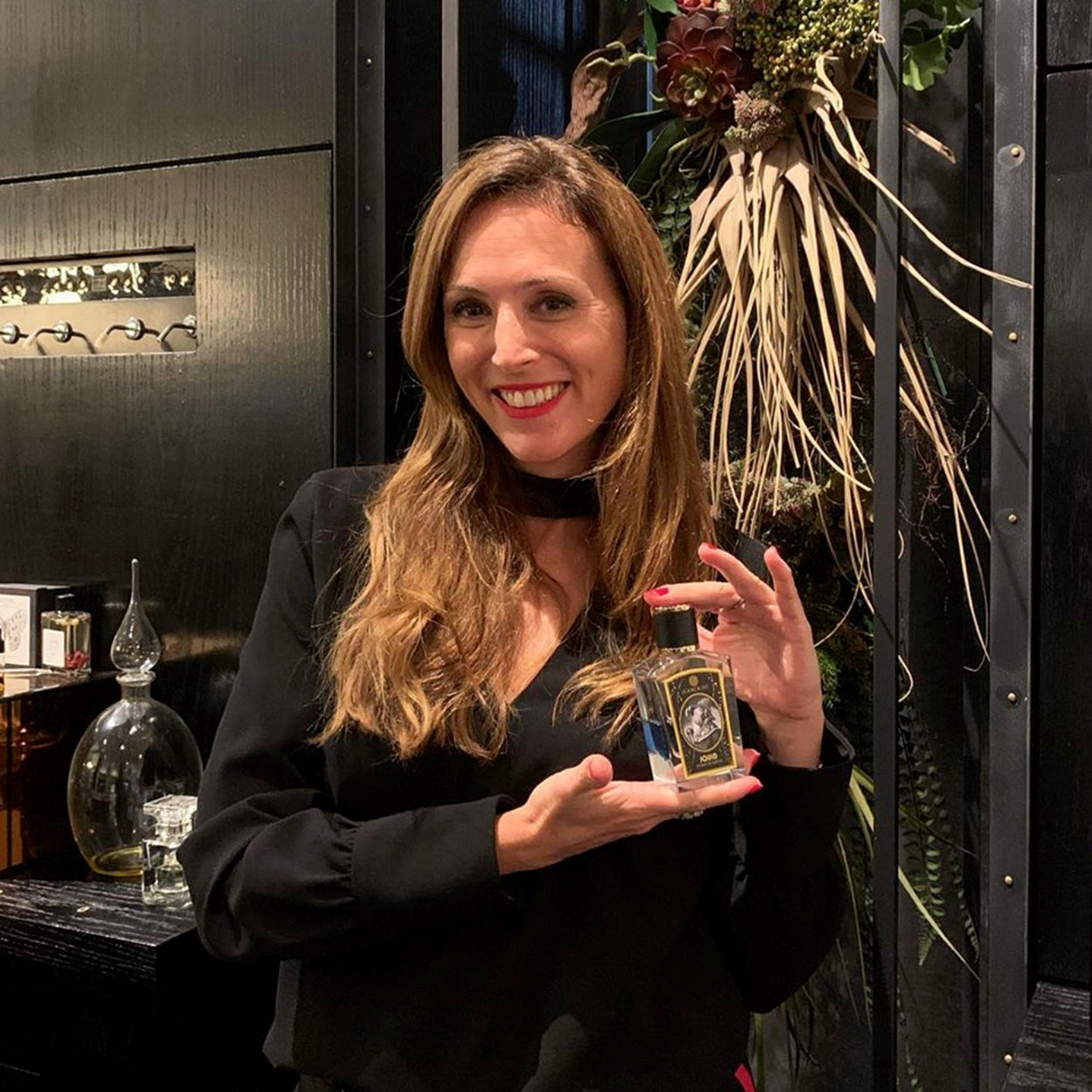 Celine Barel Holding Bottle of Zoologist Squid