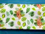 Cotton 100% Kids - sloths with green leaves on a white background