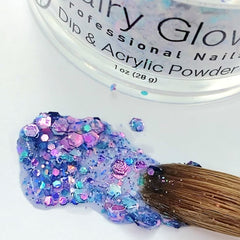 nail brush spreading blue glittery acrylic