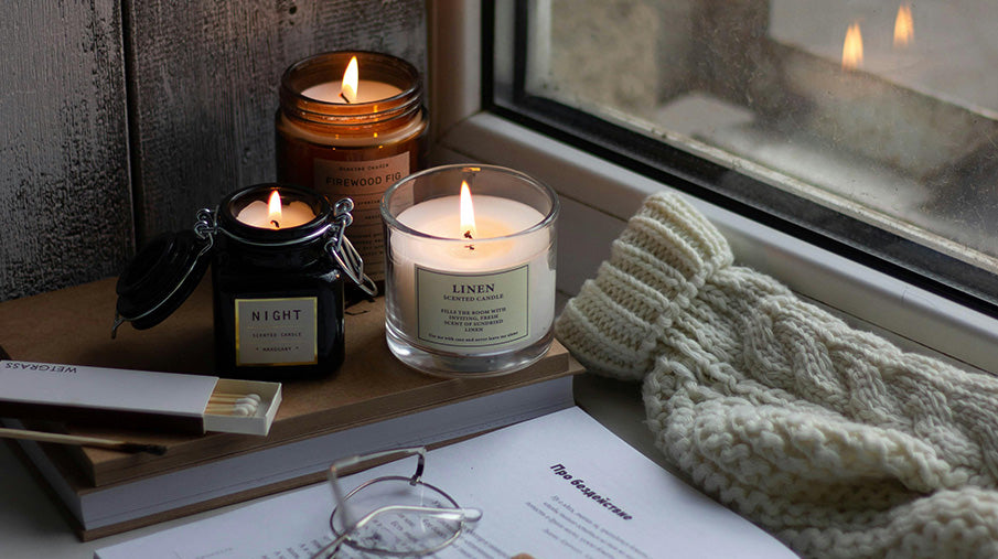 Candles and big knitted jumper on window sill