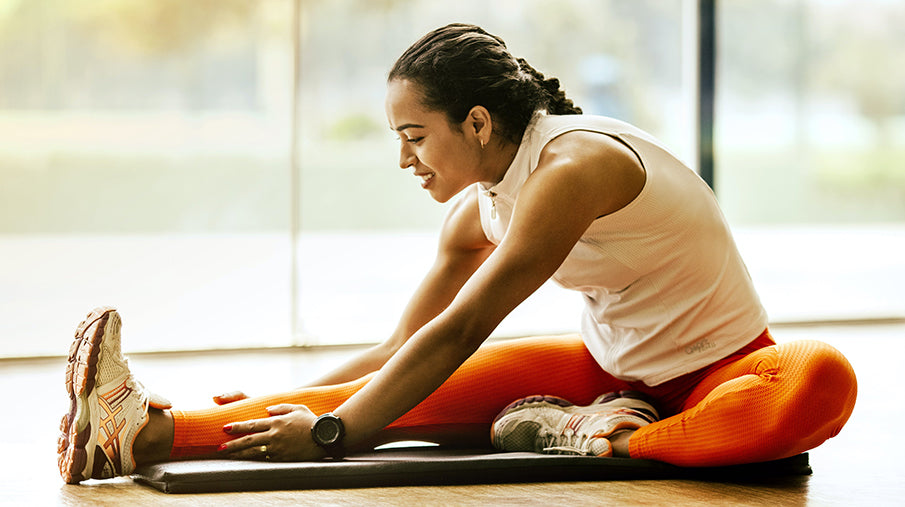 Woman stretching after a workout in a gym