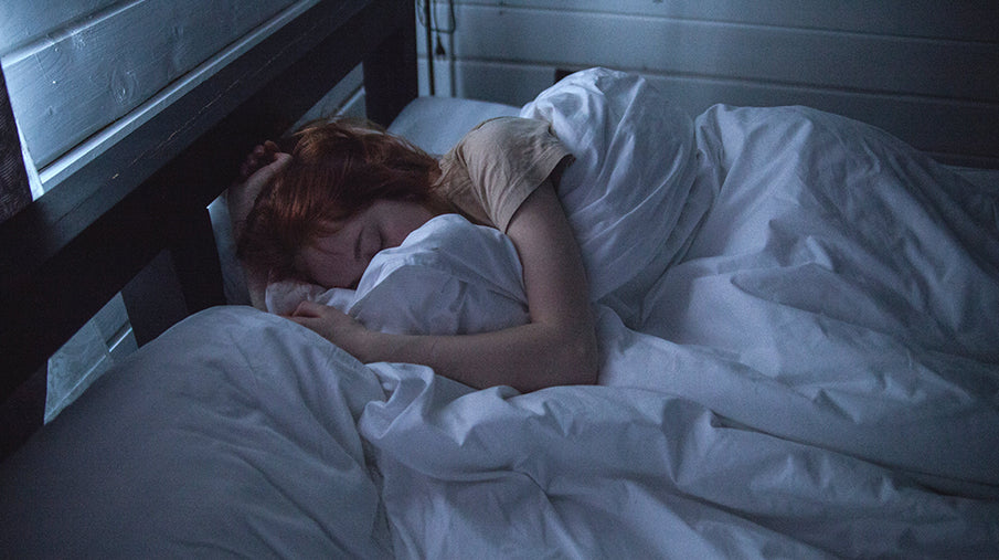 woman sleeping in bed with big cozy blanket