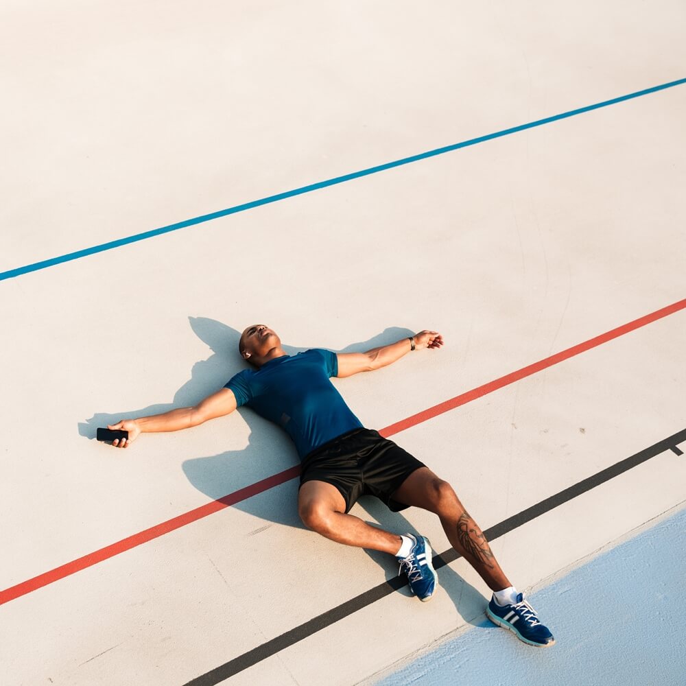 top view portrait of exhausted young fitness man