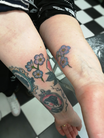 matching forget-me-not mother and daughter tattoos